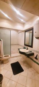 a bathroom with a sink and a toilet and a mirror at توت كينج بيراميدز فيو in Cairo