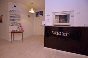 a waiting room with a welcome counter in a store at Ambiente by Next Inn in Hamburg