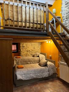 a bedroom with two beds and a staircase at Ca la Bet in Claravalls