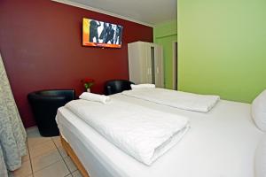 Postel nebo postele na pokoji v ubytování Ambiente by Next Inn