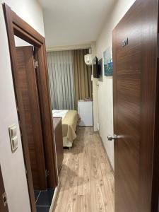 a hallway of a hotel room with a bed and a door at Reggae Apart Hotel in Istanbul