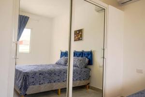 a bedroom with a mirror and a bed at Apartamentos estudio amueblados in Punta Cana