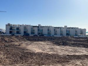 a large building in front of a construction site at Casa Teri - Los Lagos in Cotillo