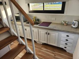a kitchen with a sink and a counter with a window at Cabañas Alpinas in Dolores