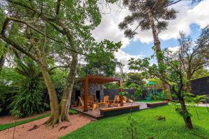 a backyard with a picnic table and a playground at Apto Maua 330 - Stay House Temporada in Canela