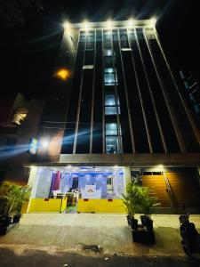 a tall building at night with lights on it at Hotel Golden inn in Bangalore