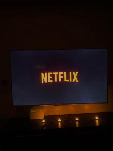 a monitor with a netflix sign on top of it at Appartements résidence rivaldi Family Only in Tangier