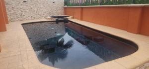 a large swimming pool in a building with a pool at Hotel Boutique Plaza Doradas in San Jos&eacute; del Cabo