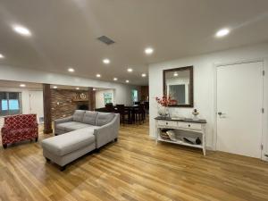 a living room with a couch and a table at Lake Pearl House in Lake Placid