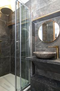 a bathroom with a glass shower and a sink at Nets Inn Apartment - Gare de Lyon in Paris