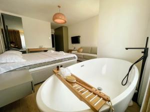 a bathroom with a bath tub and a bed at Botanica Boutique Hotel in Ulcinj