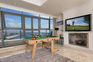 a living room with a pool table and a tv at Luxury City Center Penthouse in Galway