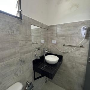 a bathroom with a sink and a toilet at Hotel Bellavista in Villa Carlos Paz