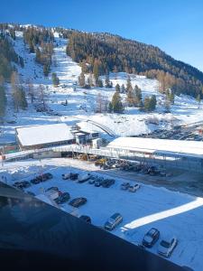 an aerial view of a parking lot with cars in the snow at Studio au centre des 4 vallées in Nendaz