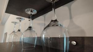 three wine glasses sitting on top of a counter at Cevahir Sky City Happy Apartment in Skopje +11 photos