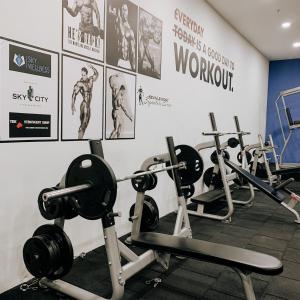 a gym with several rows of exercise machines at Cevahir Sky City Happy Apartment in Skopje