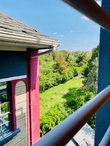 a view from a window of a house with a green field at Safari Stays Staycation Homes in Ngong