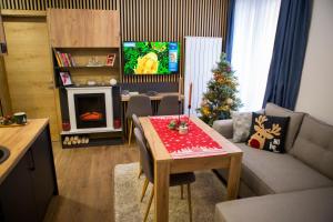 a living room with a christmas tree and a table at GreenMont Jahorina in Jahorina