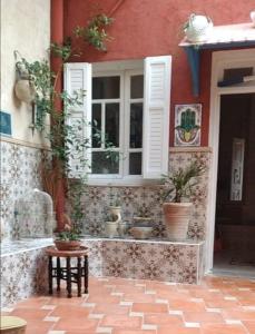 a house with potted plants on the side of it at Dar Nana in Sousse