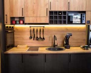 a kitchen with a sink and a counter with utensils at GreenMont Jahorina in Jahorina