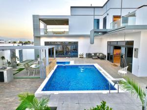 a house with a swimming pool in front of it at La Vista Chalet in Billah