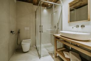 a bathroom with a glass shower and a sink at Zakątek Krupówki - Apartamenty w Centrum in Zakopane