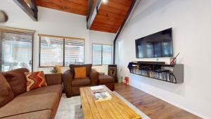 a living room with a couch and a tv at Bigwood #63 condo in Mammoth Lakes