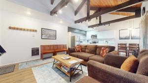 a living room with a couch and a table at Bigwood #63 condo in Mammoth Lakes