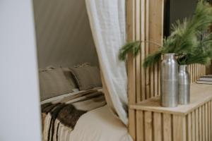 a bedroom with a bed and a table with plants on it at Zakątek Krupówki - Apartamenty w Centrum in Zakopane