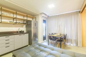 - un salon avec un canapé bleu et une table dans l'établissement Lindo apto 1 quarto em Joinville-SC MSE0302, à Joinville