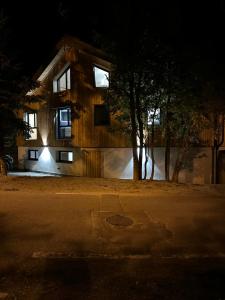 a house at night with a tree in front of it at Le Paradis Blanc luxueux Chalet Spa Serre-Chevalier in La Salle-les-Alpes