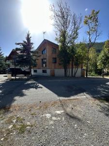 a building on a road in front of a building at Le Paradis Blanc luxueux Chalet Spa Serre-Chevalier in La Salle-les-Alpes