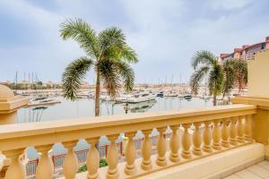 a balcony with palm trees and a marina at GLOBALSTAY. Luxury 3 Bedroom + Maid Townhouse with Sea View in Dubai