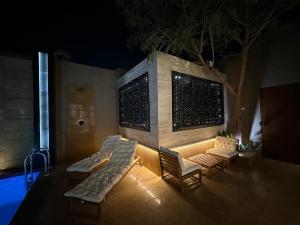 The Palms Resort (4) في الرياض: فناء مع أريكة وكراسي بجوار حمام سباحة