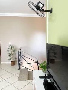 a room with a television and a phone on the wall at Casa conforto e estilo in Palmas