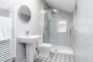 a white bathroom with a sink and a shower at The Cleveland Way, North Yorkshire in Loftus +21 photos
