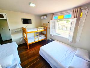 a small bedroom with two beds and a window at JF Studio Hotel in São Luís +31 photos