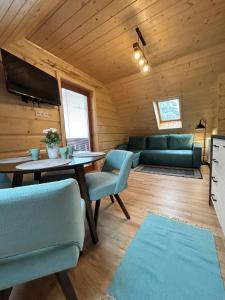 a living room with a table and a couch at Villa Milan in Tatranská Lomnica