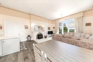 a living room with a couch and a fireplace at 1 Brathay Fell in Ambleside
