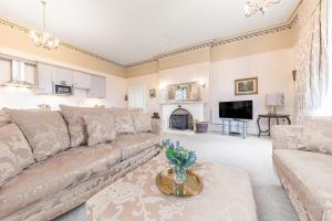 a living room with a couch and a fireplace at 1 Brathay Fell in Ambleside