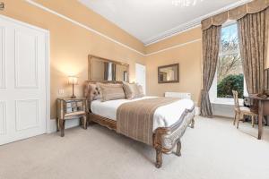 a bedroom with a large bed and a window at 1 Brathay Fell in Ambleside