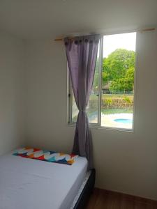 a bedroom with a bed and a window at Apartamento Amoblado en Ibague in Ibagué +16 photos
