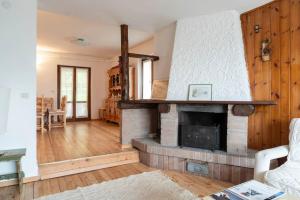 a living room with a brick fireplace in a house at Casa Polsa, 280 m Piste in Prada