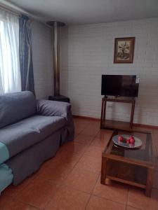 a living room with a couch and a coffee table at Casa Foresta Curicó in Curicó