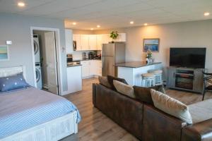 a living room with a couch and a kitchen at Waterfront Home with a View in Groton