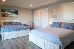 a bedroom with two beds and a table at Waterfront Home with a View in Groton