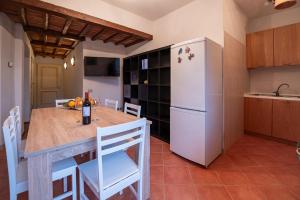 a kitchen with a table and a refrigerator at Casa Gilda in Lucardo +27 photos