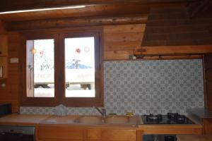 a kitchen with a sink and a window at Chalet at the foot of the Nordic domain in La Clusaz