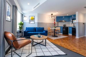 a living room with a blue couch and a table at Gia Sydney in Sydney