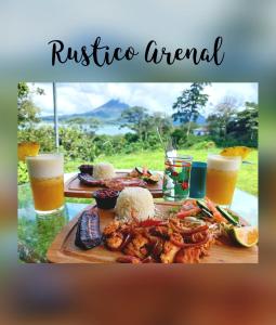 a table with a plate of food and two glasses of beer at Rustico Arenal B&B in Fortuna